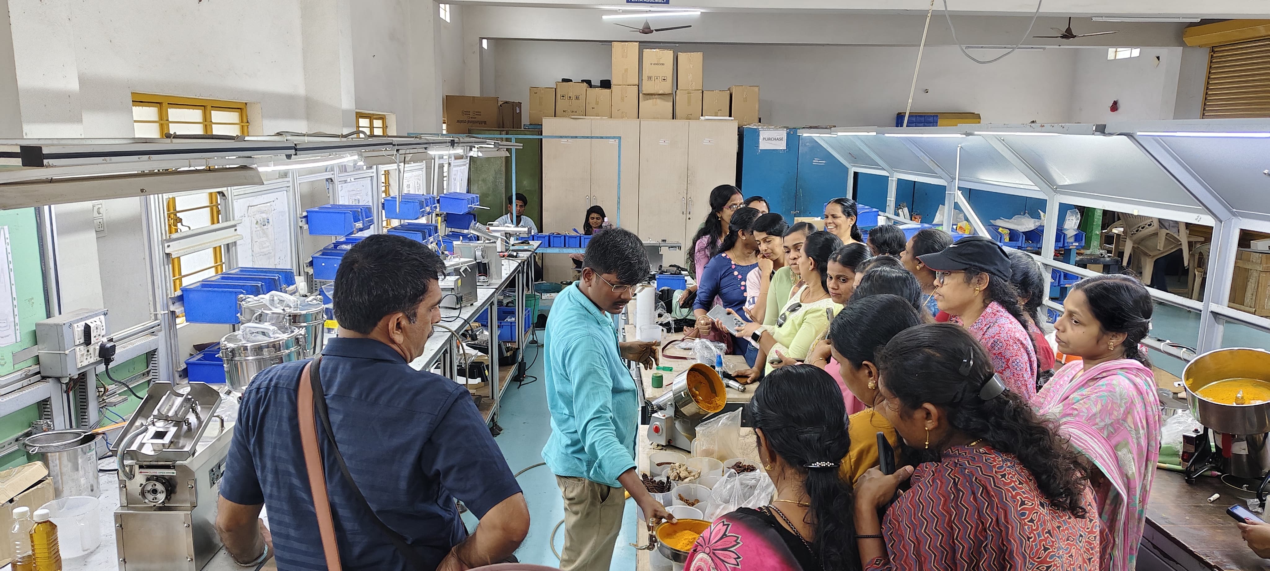 Visitors watching a machine demonstration at the Hakura factory