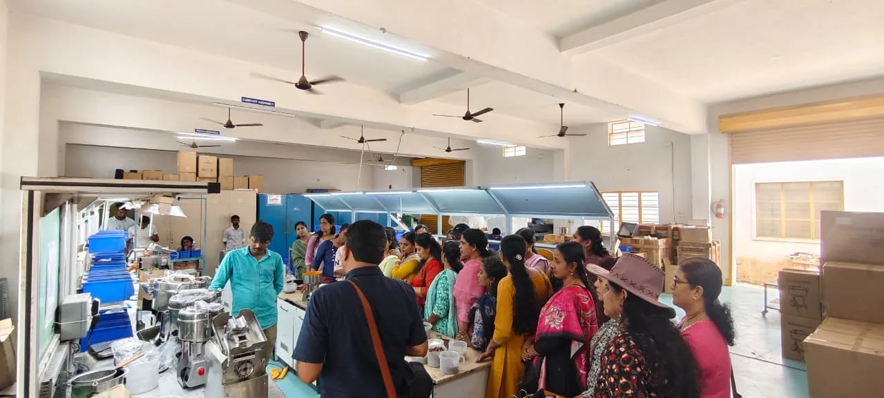 Visitors watching a live Hakura machine demonstration at the factory